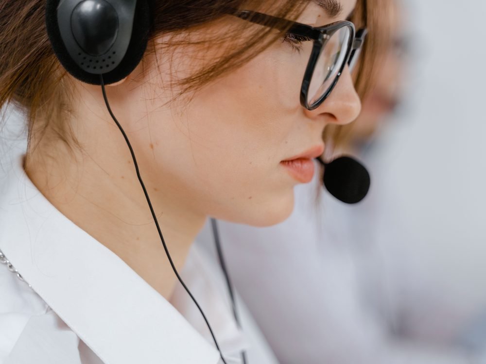 Contact Centre vs Call Centre Contact centre vs call centre: an agent taking a customer call on a headset