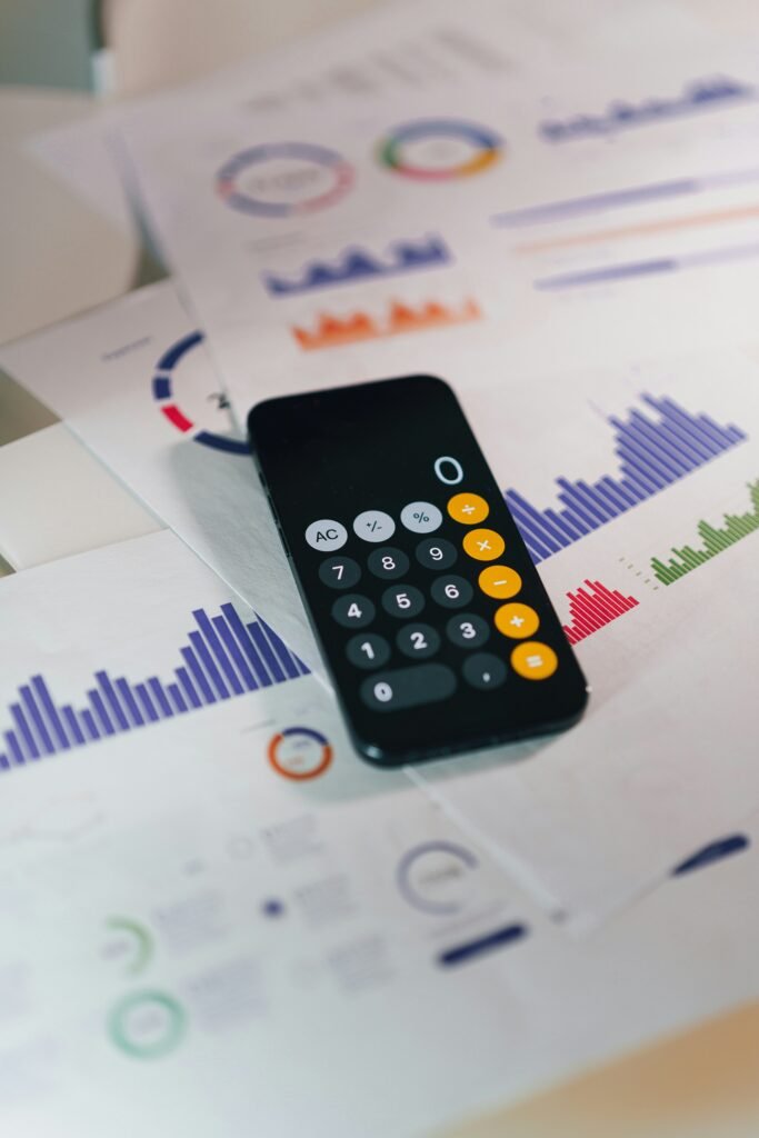 Calculator and financial reports on a desk, the everyday work behind business phone systems for financial services