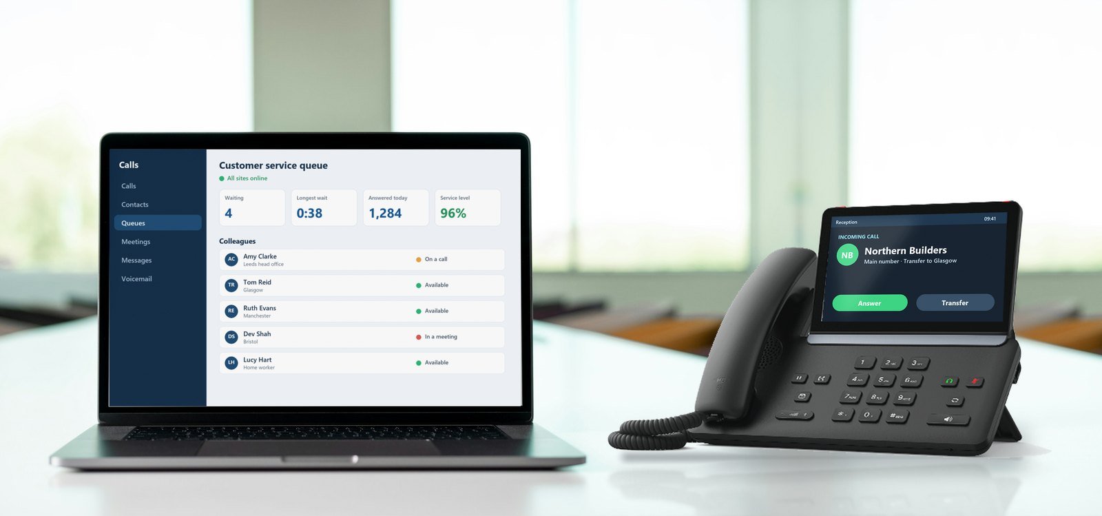 Large Business Phone Systems Touch-screen office desk phone showing an incoming call beside a laptop running the desktop calling app with a customer service queue